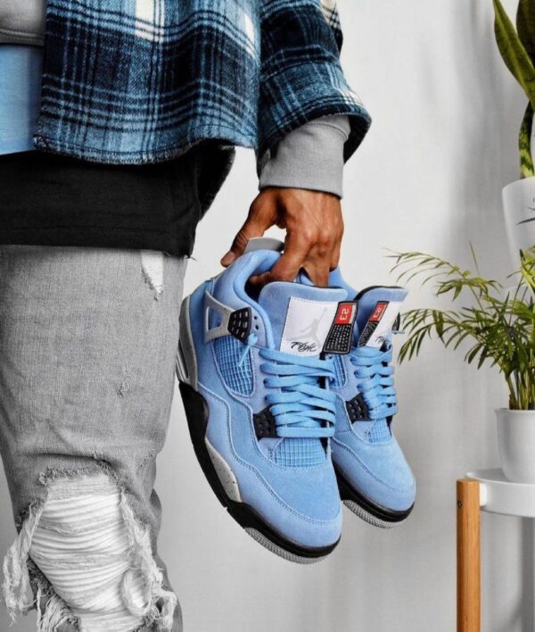 "Jordan Retro 4 University Blue sneakers featuring premium suede upper with black and white accents, perfect for a trendy and comfortable look."