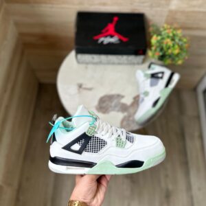 "Jordan Retro 4 Seafoam sneakers in white leather with seafoam green accents, perfect for a stylish and comfortable look."