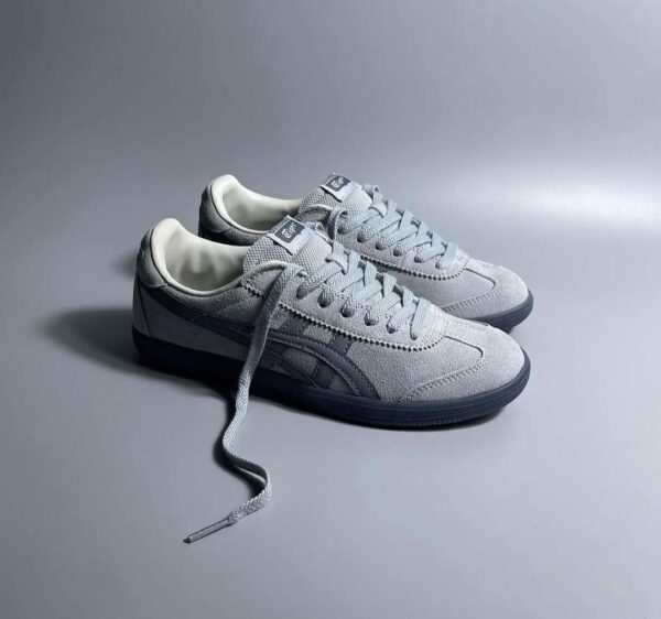 Side view of Onitsuka Tiger Tokuten Grey sneakers showcasing sleek design.