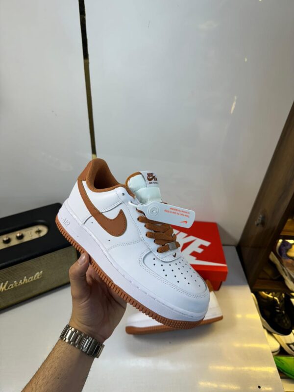 Side view of Nike Airforce Girls sneaker showcasing sleek design.