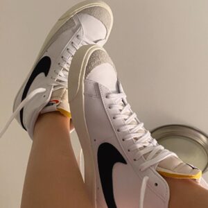 "Nike Blazer 77 Girls sneakers in classic white leather with a retro swoosh design, perfect for young women looking for stylish and comfortable casual footwear."