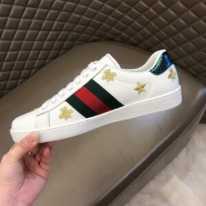 "Gucci Star Bee Ace White Sneaker featuring embroidered star and bee motifs on a premium white leather upper, with signature red and green web stripes, perfect for luxury fashion enthusiasts."