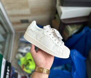 "Adidas Superstar Cappuccino Off White sneaker with a stylish off-white upper and iconic three stripes design.