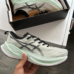 "ASICS FF Super Blast in hand showcasing its sleek design and premium quality."