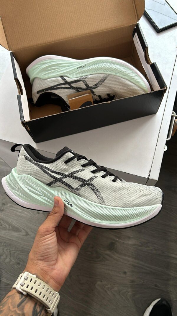 "ASICS FF Super Blast in hand showcasing its sleek design and premium quality."