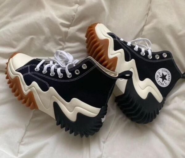 Front view of Converse Motion sneakers showcasing sleek design.