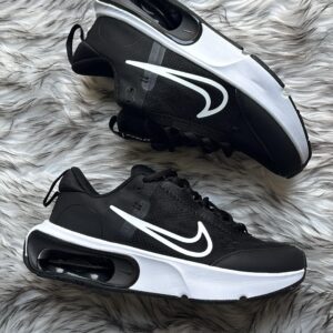 Side view of Nike Airmax Interlock sneakers in black and white.